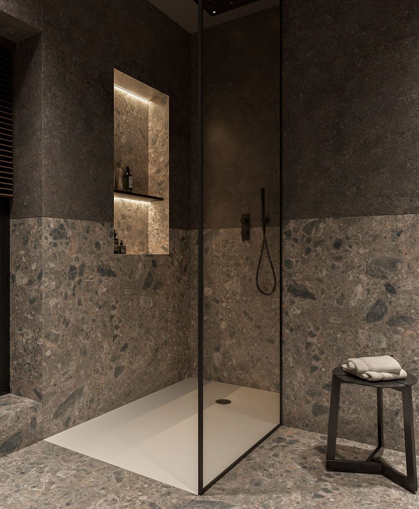 Une douche dans une salle de bain grise et des étagères éclairées au mur